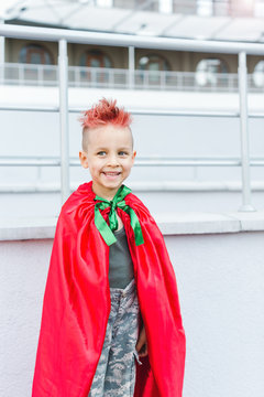 Kid superhero in a red cloak
