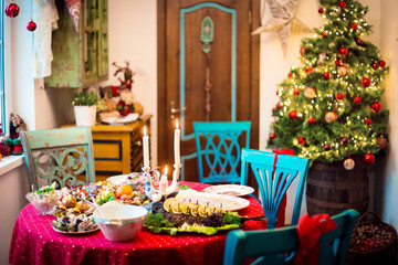 New Year or Christmas interior and festive table with a food.