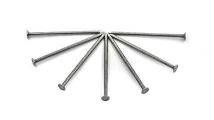 Big metal nails placed in the shape of a fan on a white isolated background_