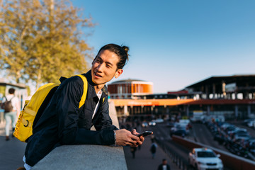 Young man using smartphone outdoors