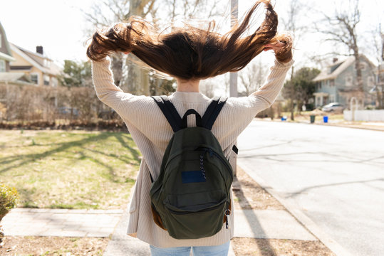 Teenager flipping hair over shoulder