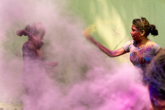 Two Teenage Girls Throwing Gulal During Holi Festival
