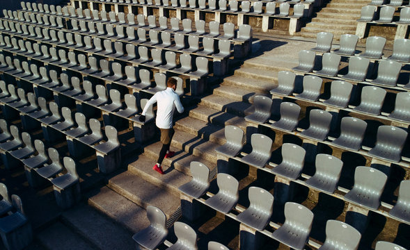 Sportsman running up stadium steps