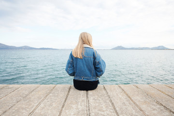 Lonely girl on boardwalk