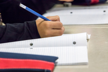 Kids learning and writing in school.