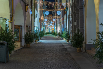 Fototapeta na wymiar Bolzano, Italy 01 December 2019: Christmas decor on the night streets of Bolzano in South Tyrol.