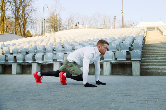 Athlete sprinting near arena seats