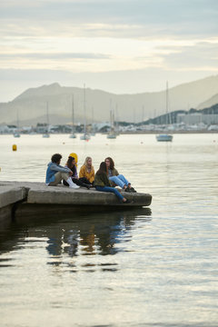 Teens on pier in the evening.