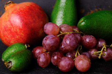 Fresh fruits and berries on black background.	