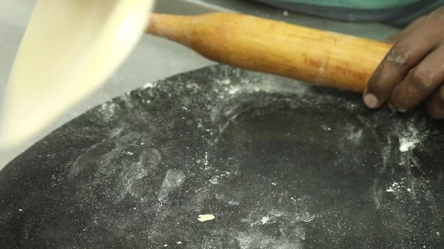Rolling Out Round Indian Wheat Roti Phulka Fulka Tortila With Wooden Belana and Chakla