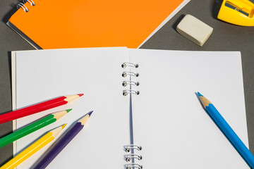 Background of stationery items notepad pencils shot closeup.