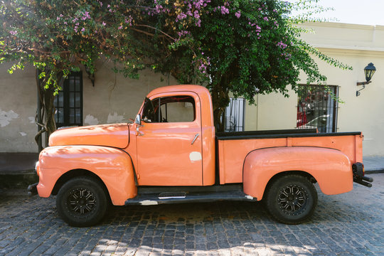 Side View Of Orange Vintage Pickup Truck