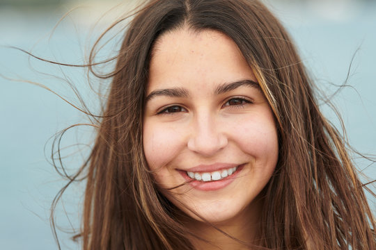 Smiling woman near blue sea