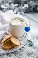 Cup of cacao with marshmallow and cookies on Christmas wooden background