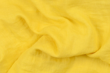 close up crumpled yellow cotton fabric background