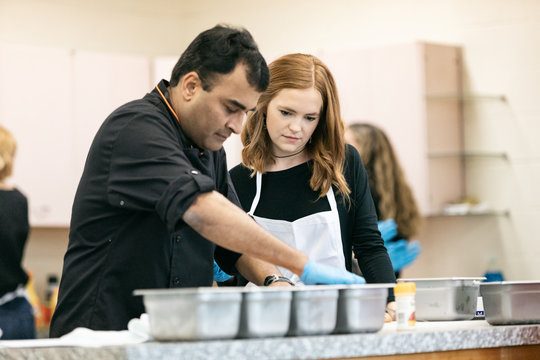Class: Woman Watches While Chef Prepares Ingredients