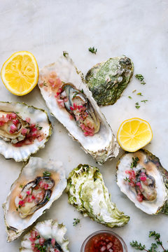 Cooked oysters with mignonette sauce and lemon