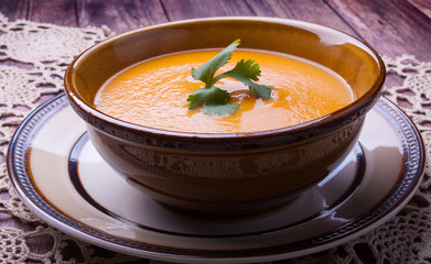 Closeup on a carrot cream-soup with cilantro