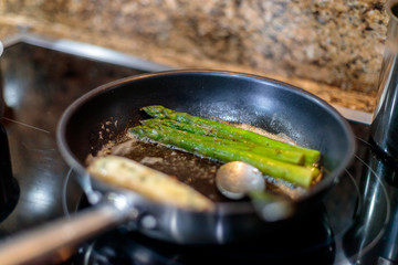 High angle shot of grilled asparagus in a roaster with blurred background
