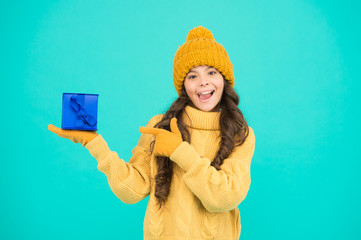 Shopping day. Child excited about unpacking her gift. Small cute girl received holiday gift. Enjoy receiving presents. Christmas gifts for kids. Kid little cheerful girl hat long hair hold gift box