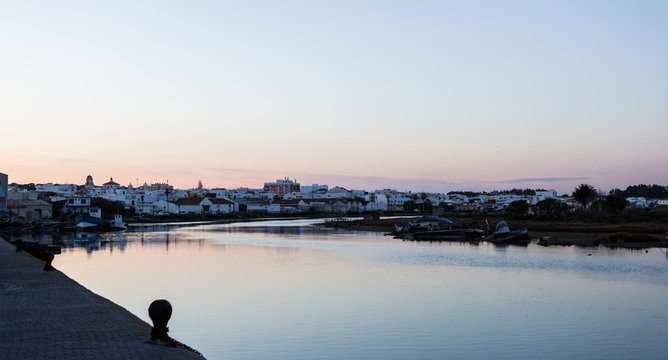 View of a Spanish town at dusk over a river