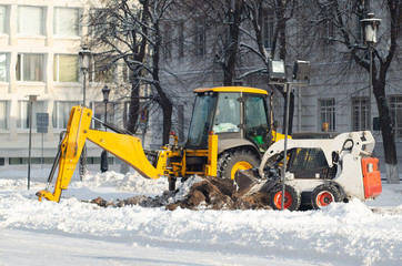 City municipal services are engaged in snow removal. Machines for cleaning snow. A tractor cleans...
