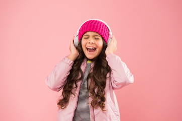 Enjoy sound. Girl cute schoolgirl pink clothes wear headphones listen music. Kid listen music....