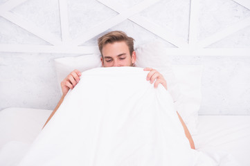Man looking under blanket. Male reproductive system. Why men get morning erections. Normal...