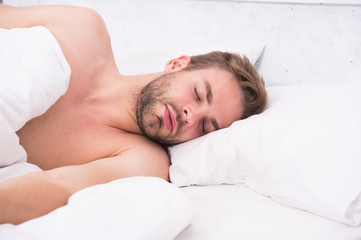 Fototapeta na wymiar Circadian rhythm regulates sleep wake cycle. Man handsome unshaven guy in bed. Enough amount sleep every night. Tips sleep better. Bearded man relaxing on pillow. Soft pillow. Health care concept