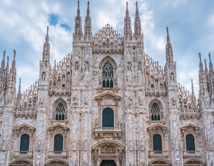 Fototapeta premium Milan Cathedral in Italy, known as Duomo di Milano is the largest and most complex Gothic building in Italy. Catholic church made of white marble.