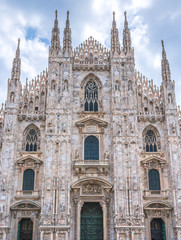 Fototapeta na wymiar Milan Cathedral in Italy, known as Duomo di Milano is the largest and most complex Gothic building in Italy. Catholic church made of white marble.