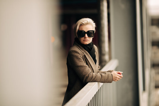 Portrait Of Young Blond Androgyne Woman With Big Sunglasses