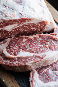 Large raw meat steaks on table
