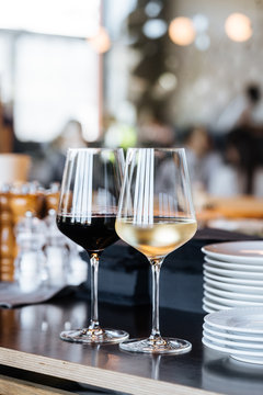 Glasses of red and white wine on table in restaurant
