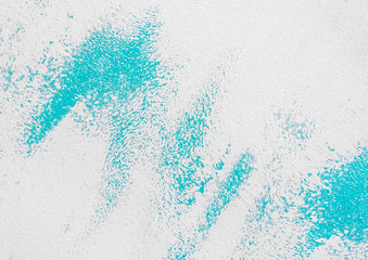 Traces or spots of blue paint on a white or gray wall for background