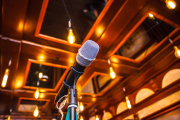 Microphone with bokeh background at stage. (selective focus) Close up the microphone on the podium...