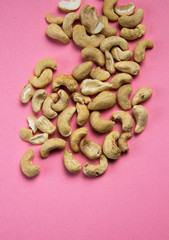 organic whole cashew peeled pink background
