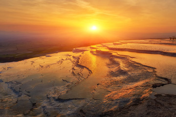 Beautiful sunrise and Natural travertine pools and terraces in Pamukkale.