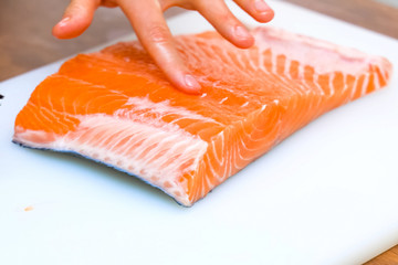 Butchering salmon, piece of salmon red fish meat.