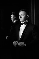 Stylish groomsmen happy groom getting ready in the morning for wedding ceremony. 