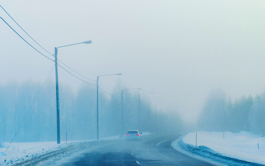 Car on Winter road with snow in Finland. Auto and Cold landscape of Lapland. Automobile on Europe forest. Finnish City highway ride. Roadway and route snowy street trip. Driving