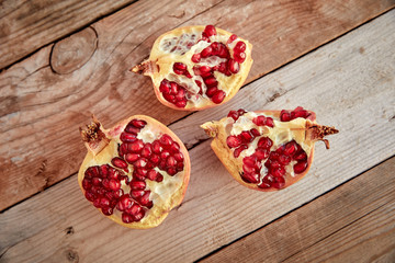 ripe organic pomegranate on teh wooden background