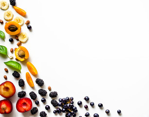 Creative  layout  of fresh summer fruits on a white background with space for text. 