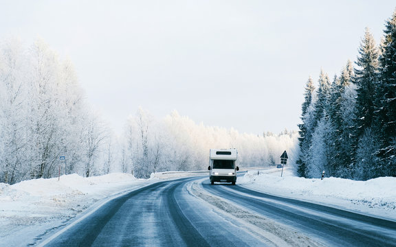 Mini Van on Winter road with snow in Finland. Car and cold landscape of Lapland. Europe forest. Finnish City highway ride. Roadway and route snowy street trip. Driving