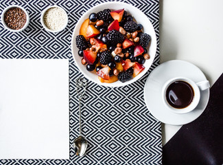 Creative layout  of a Yummy breakfast. A composition of fresh summer fruits, muesli, grains, plums on a cutting board and tablecloth. Yummy food. Top view with space for text.