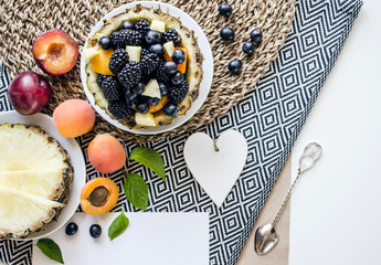 Creative  layout  of a Yummy dessert made from fresh summer fruits and berries on the table. 