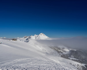 Fototapeta na wymiar Beautiful landscape of Caucasus Mountains on ski resort Krasnaya Polyana on background clear sky