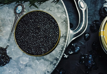 Black caviar served on table. Exquisite delicacy of black sturge