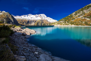 Fototapeta na wymiar Gelmer Lake near by the Grimselpass in Swiss Alps, Gelmersee, Switzerland, Bernese Oberland, Switzerland.
