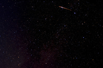 Obraz na płótnie Canvas photograph of satellite or shooting star as it passes over deep sky